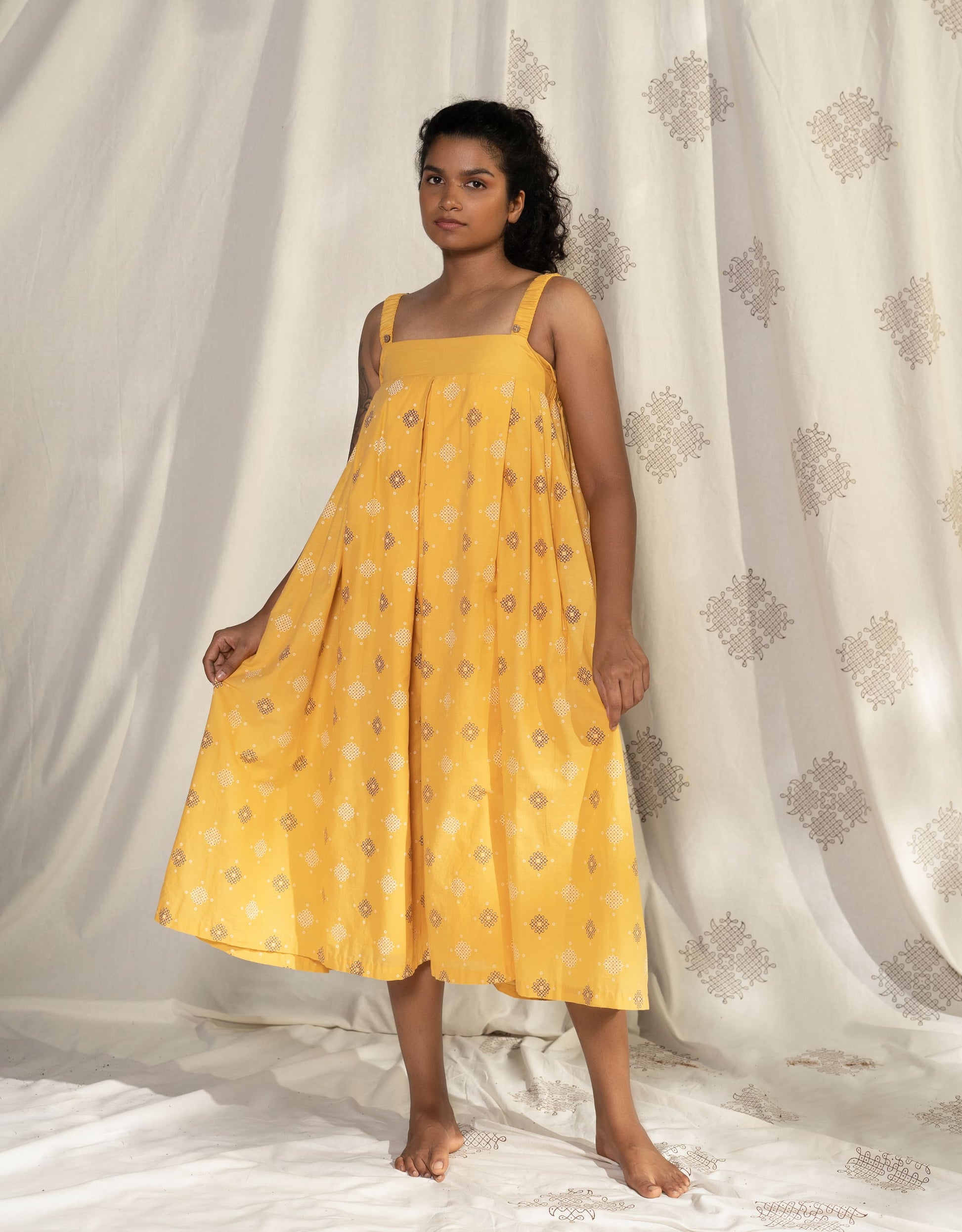 Hueloom yellow pleated convertible jumpsuit with detachable sleeve front view showing without sleeve option