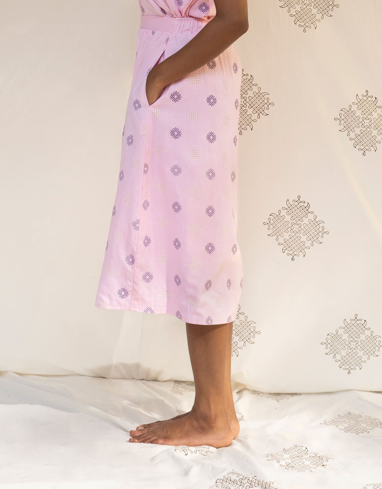 Side view of Hueloom's Reversible Midi Skirt in Light Pink Kolam print
