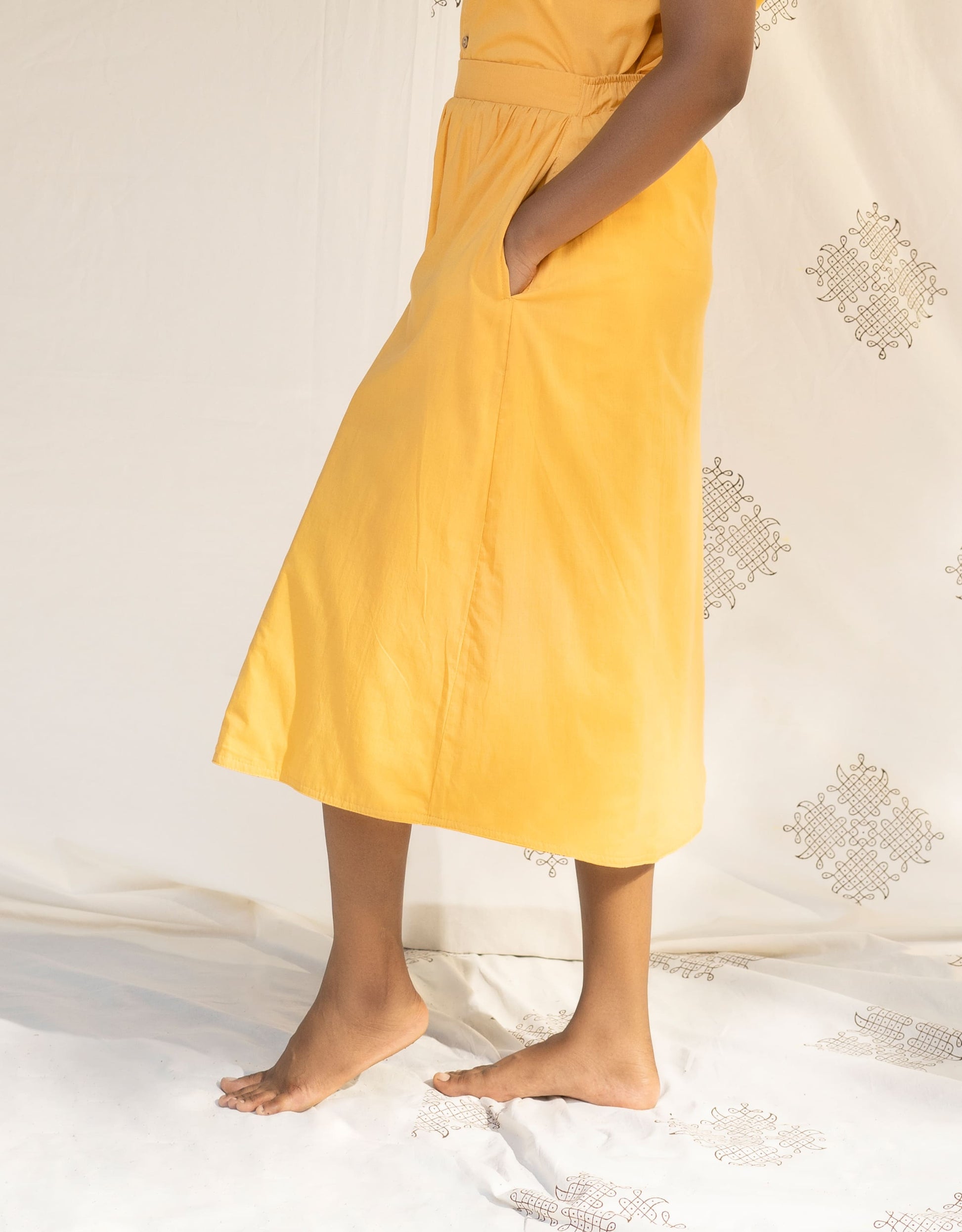 Side view of Hueloom's Reversible Midi Skirt in Yellow