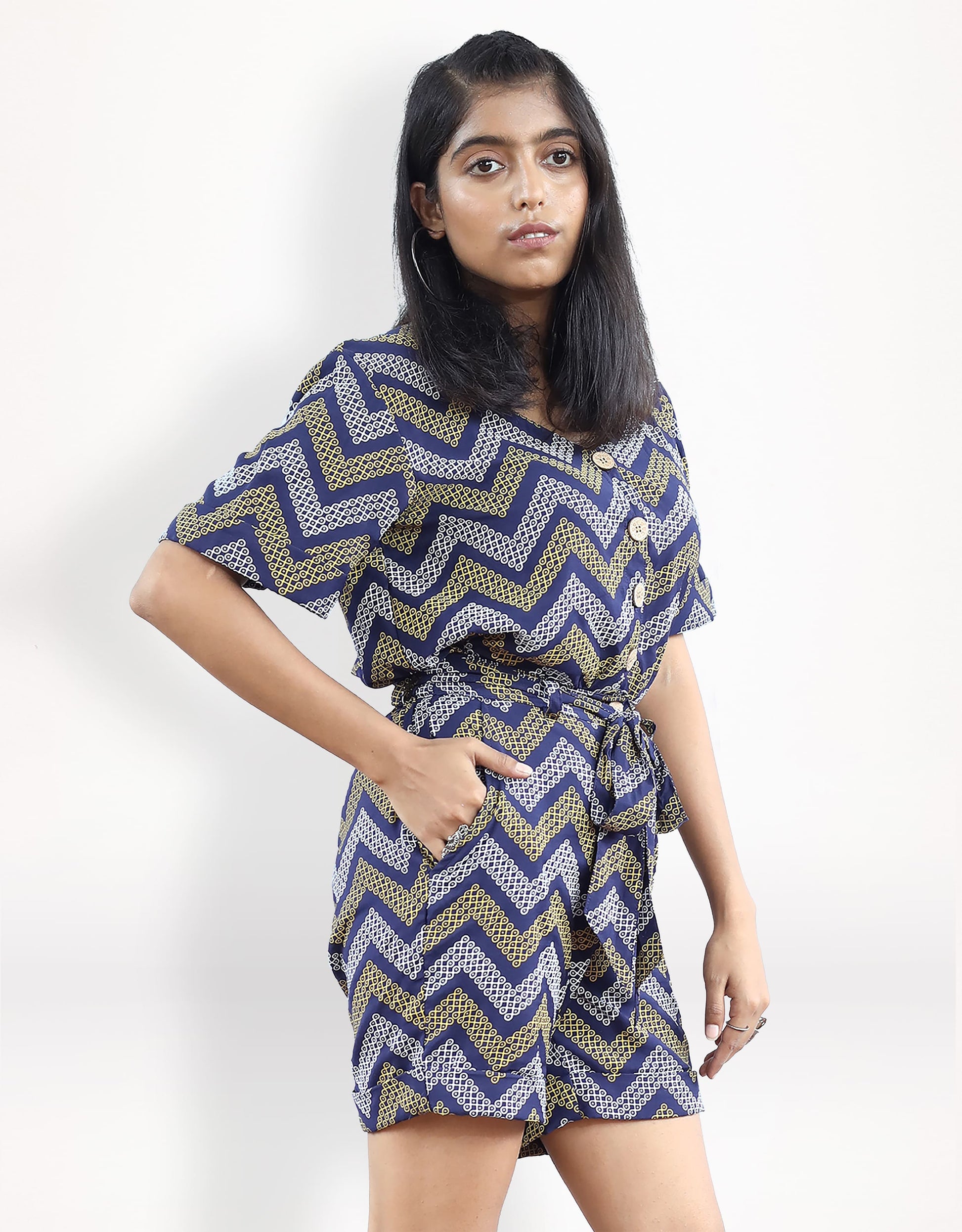 Side view of Hueloom's detachable romper in navy with kolam print and pockets.