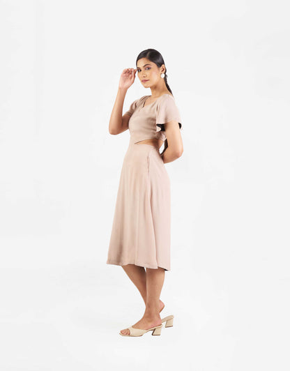 Side view of Hueloom's Reversible Cut-out dress in champagne.