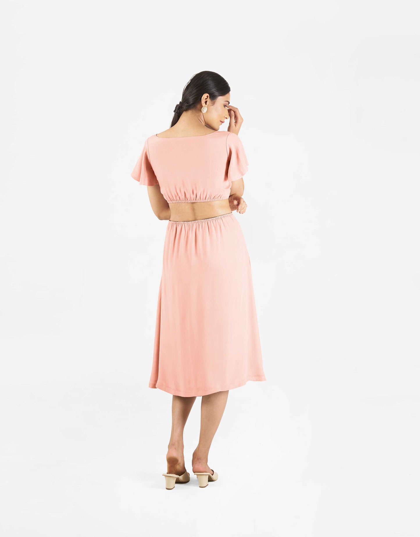 Back view of Hueloom's Reversible Cut-out dress in coral.