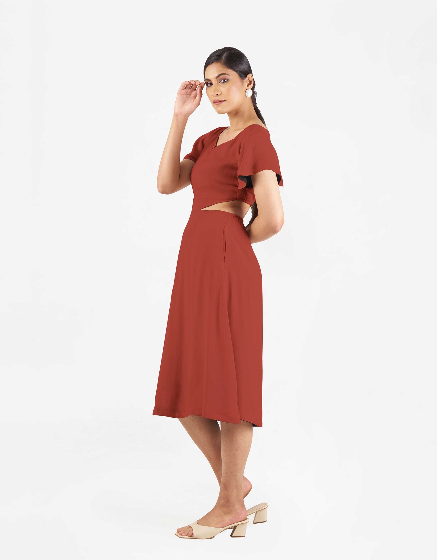 Side view of Hueloom's Reversible Cut-out dress in rust colour.