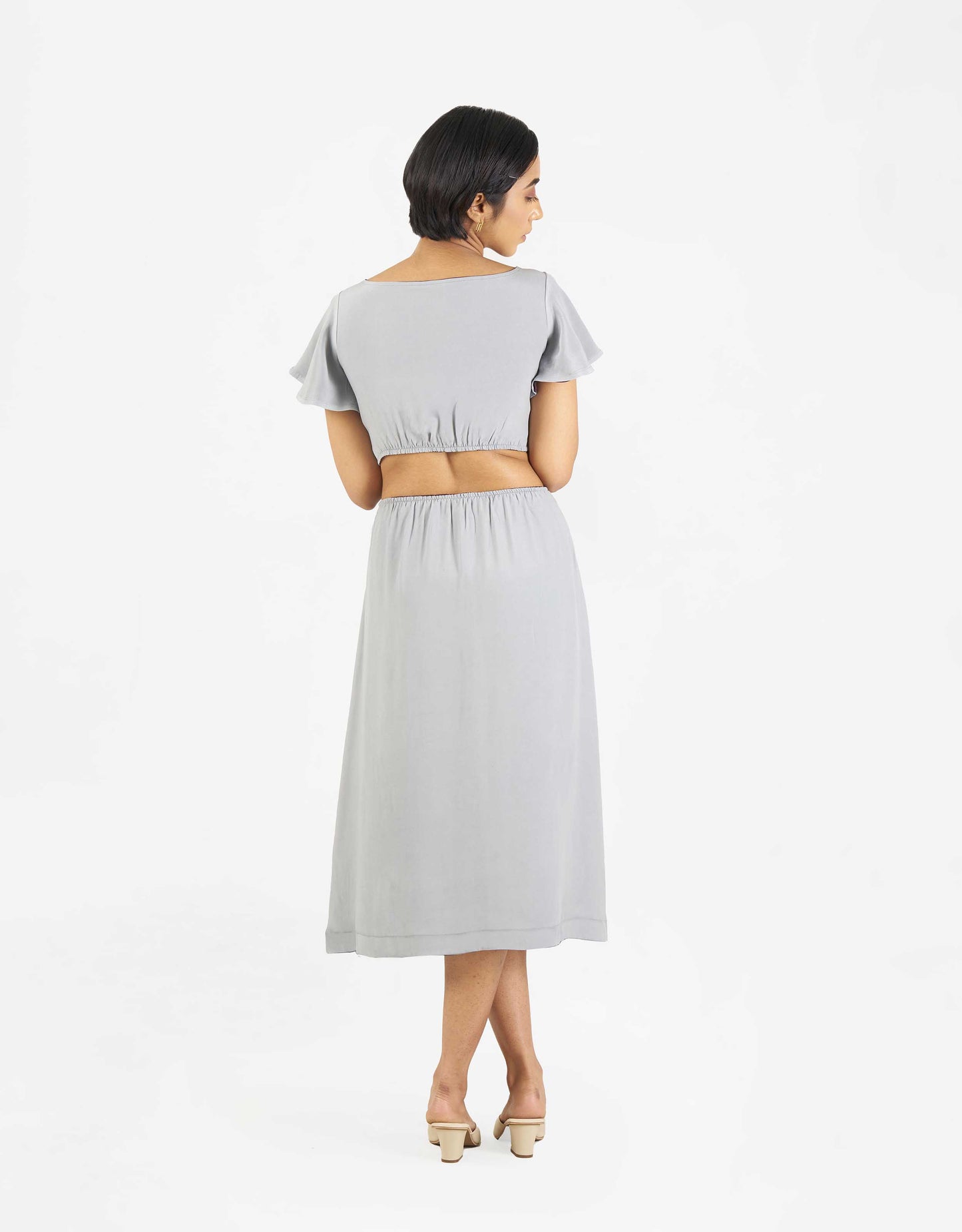 Back view of Hueloom's Reversible Cut-out dress in grey.