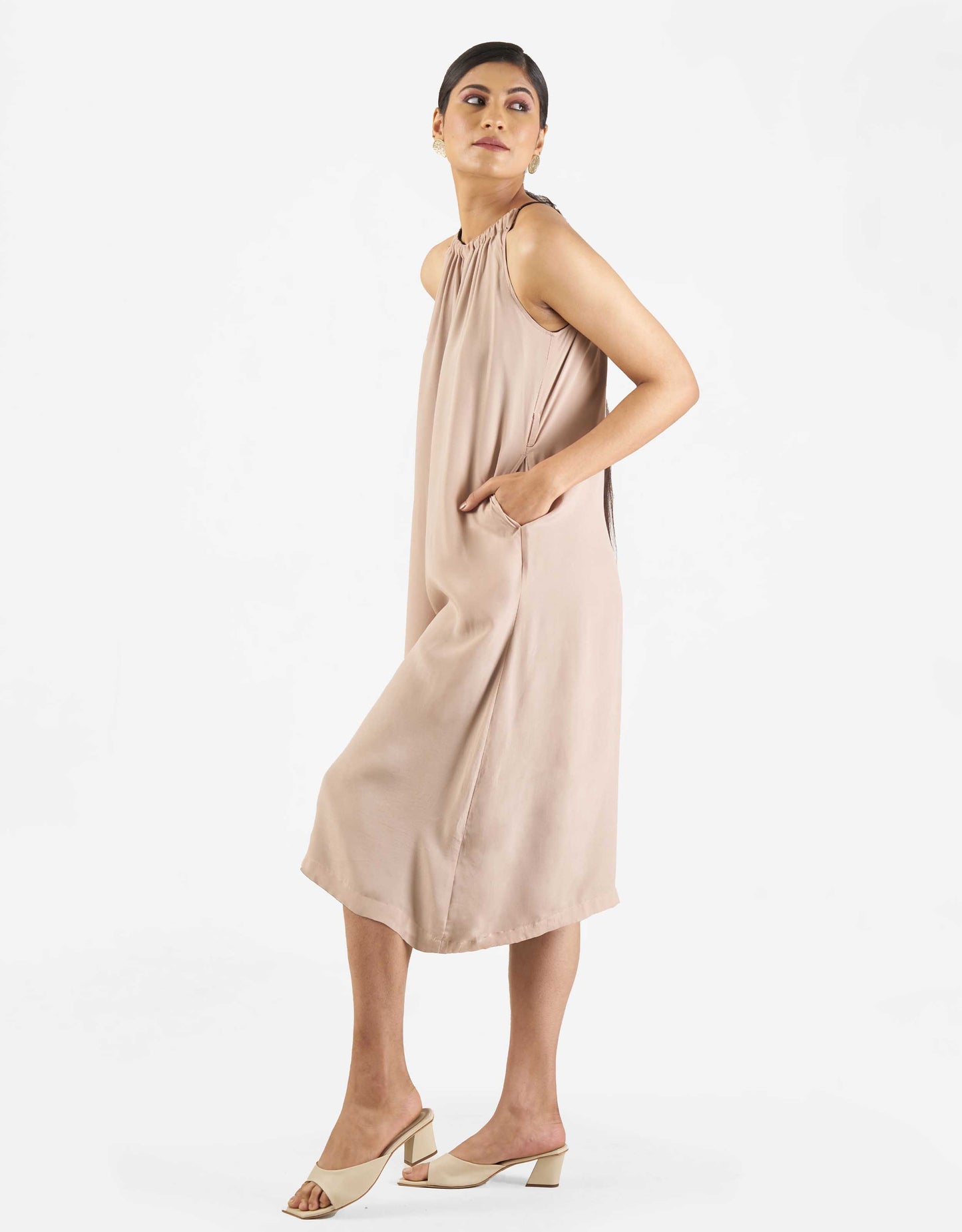 Side view of Hueloom's Reversible jumpsuit in champagne.