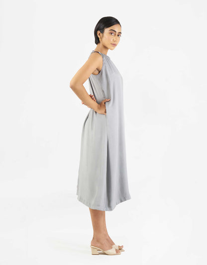 Side view of Hueloom's Reversible jumpsuit in grey with functional pockets.