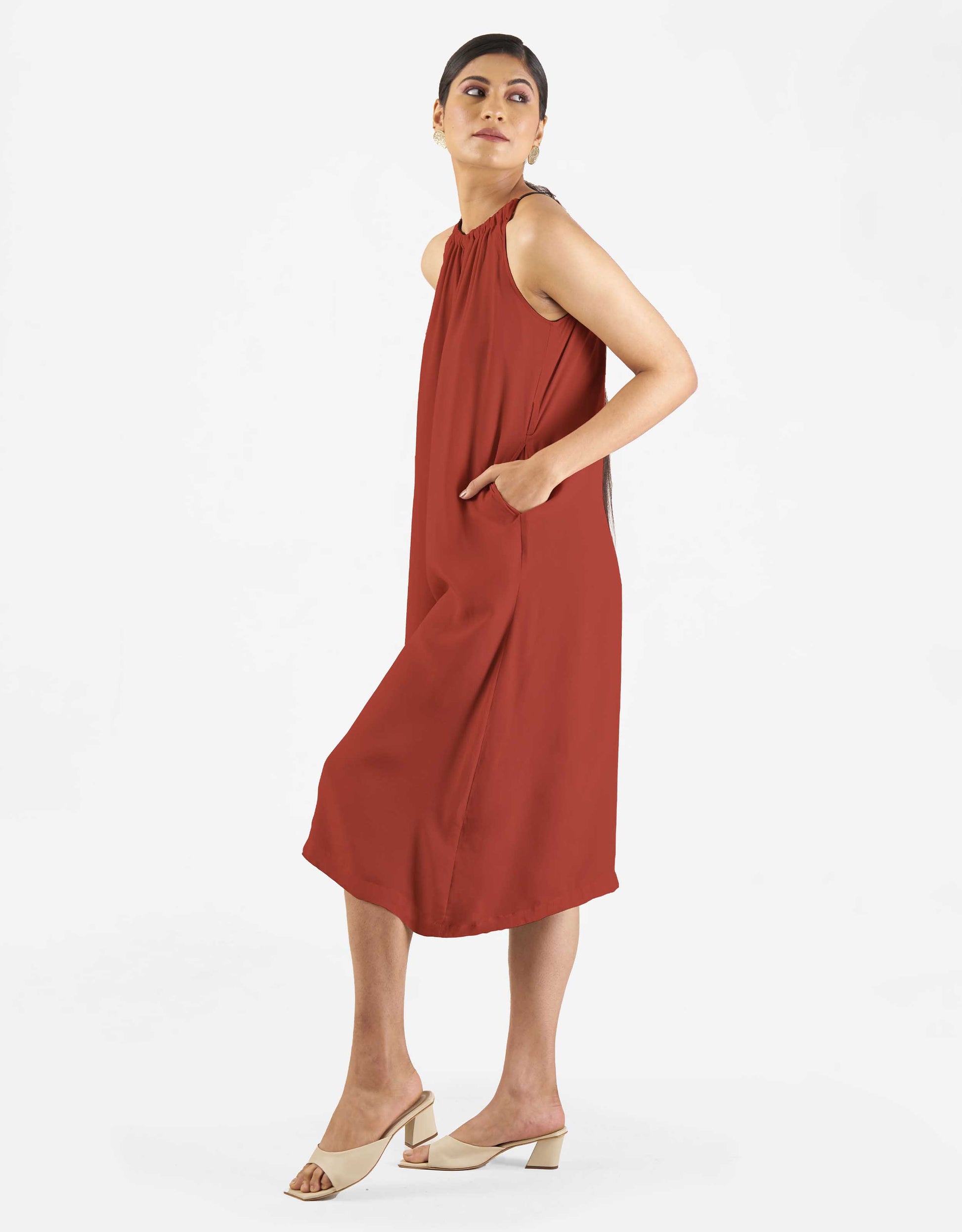 Side view of Hueloom's Reversible jumpsuit in rust colour.