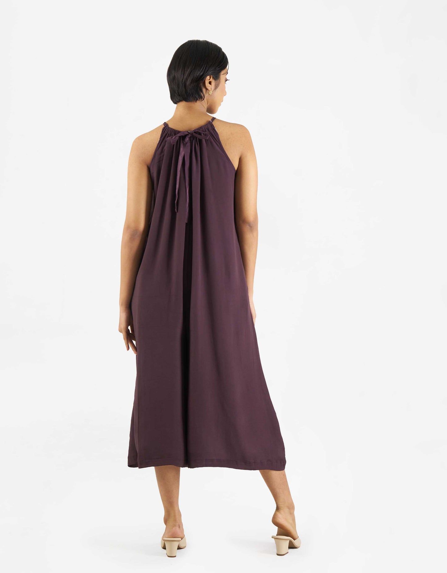 Back view of Hueloom's reversible jumpsuit from suit-up capsule in purple.