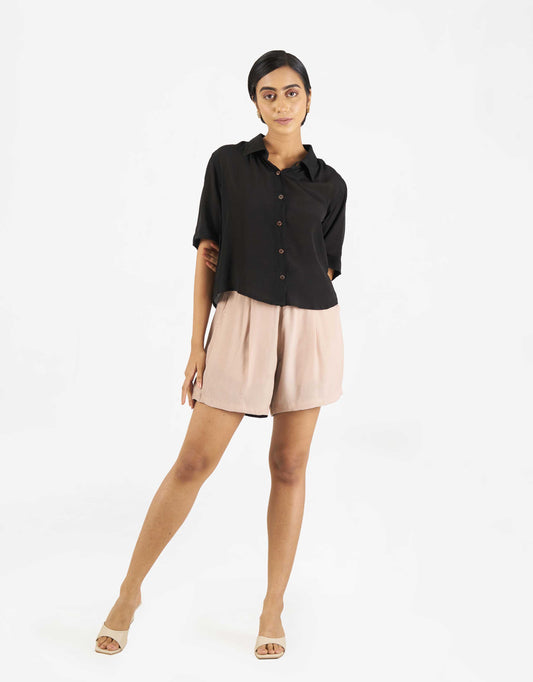 Front view of Hueloom's Boxy shirt in black with shorts.