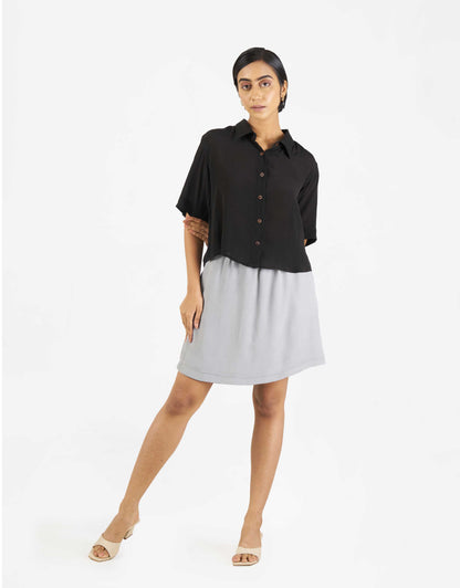 Front view of Hueloom's Boxy shirt in black with skirt.