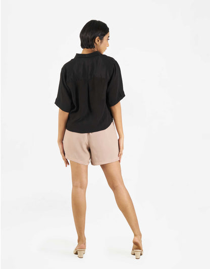 Back view of Hueloom's Boxy shirt in black with shorts.