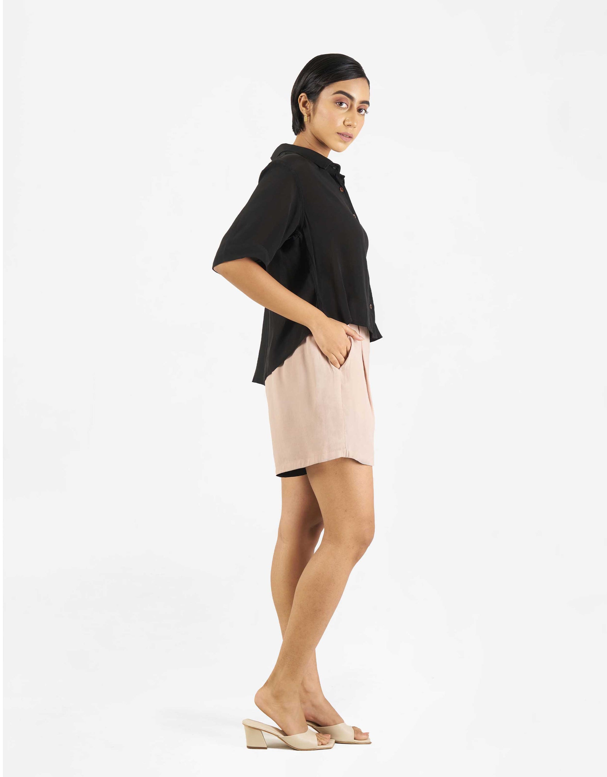 Side view of Hueloom's Boxy shirt in black with shorts.