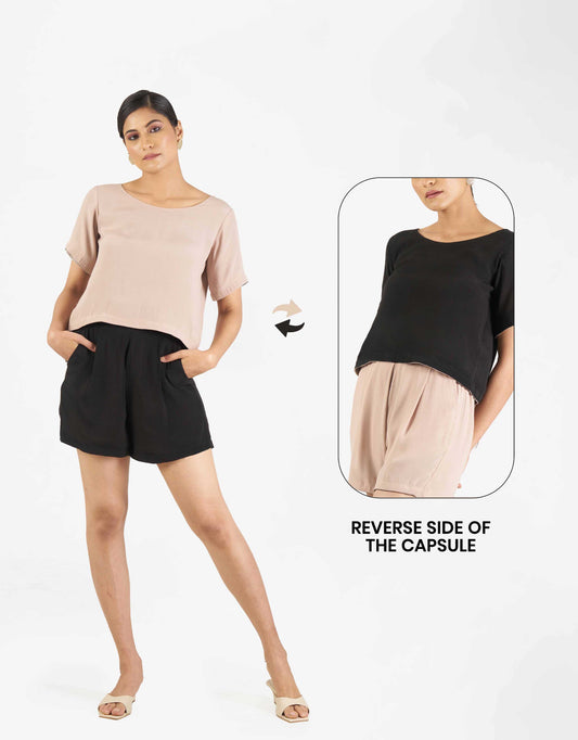 Front view of Hueloom's top shot reversible capsule with reversible top and shorts in black and champagne with reverse side. 