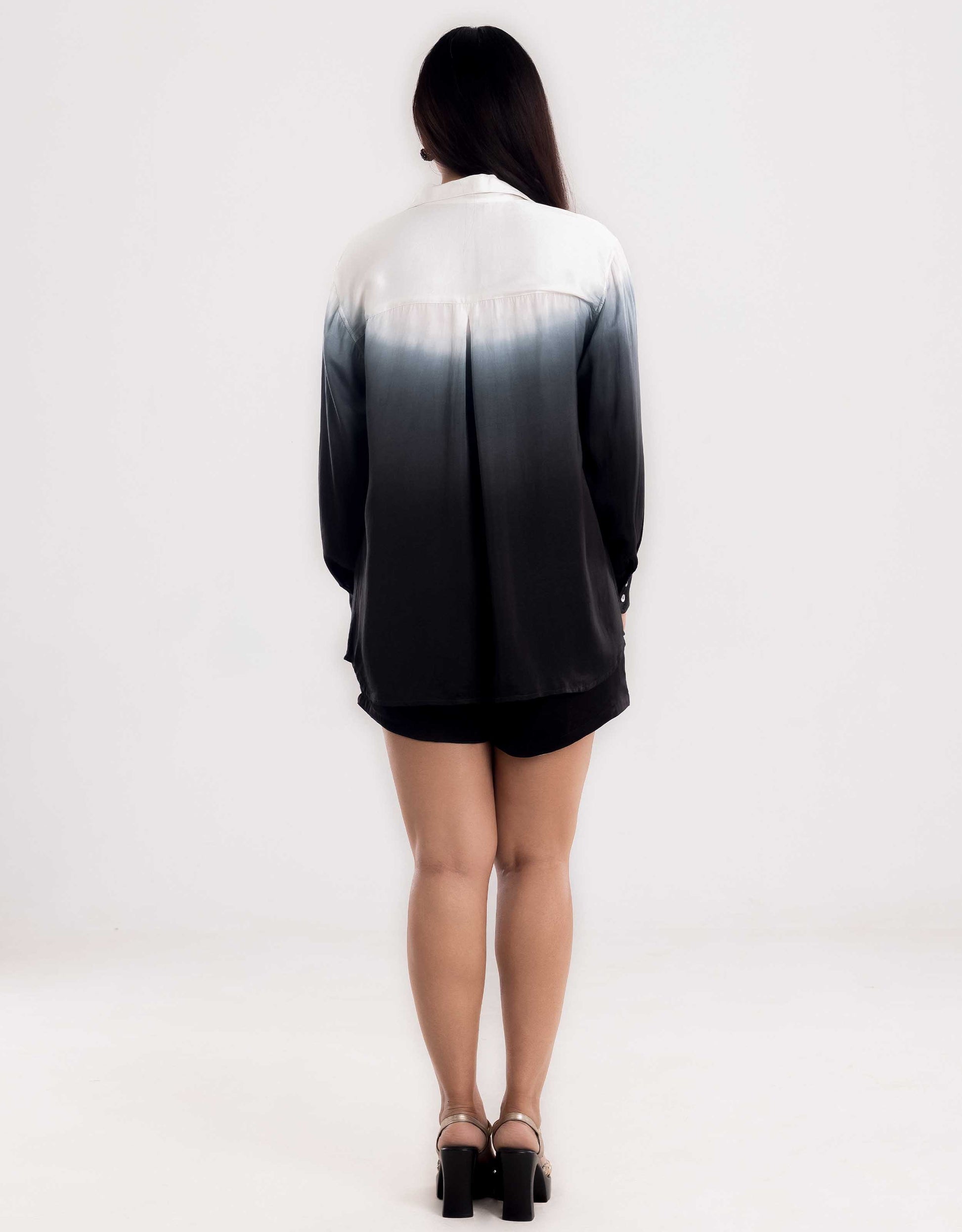Back view display of Hueloom's Cosmopolitan capsule with oversized shirt, bandeau top and shorts in black.
