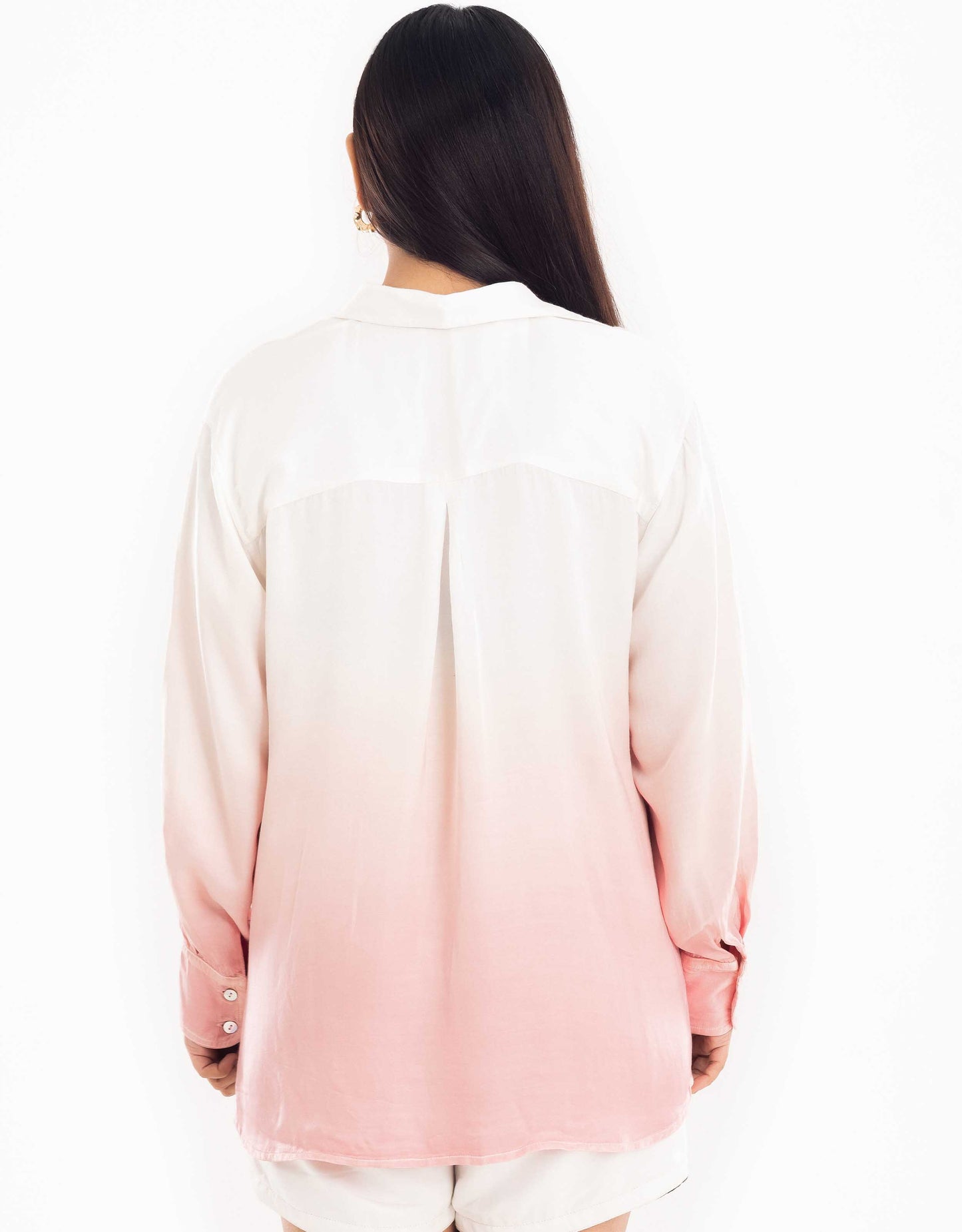 Back view display of Hueloom's Cosmopolitan capsule with oversized shirt, bandeau top and shorts in rose-gold.